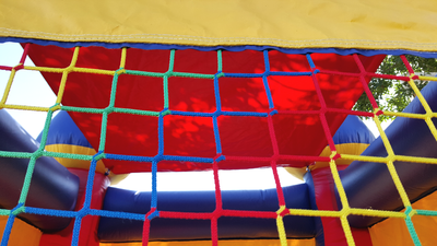 Inflatable Mini Bounce House Rental - close up view of the colorful net on window.