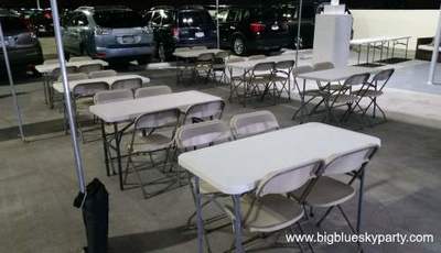 Beige folding chairs and 4 ft rectangular tables for rent in Los Angeles.
