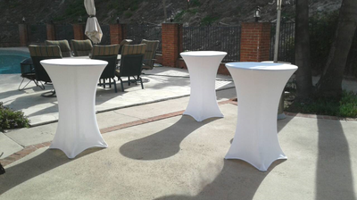 Highboy cocktail tables with white spandex tablecloths.