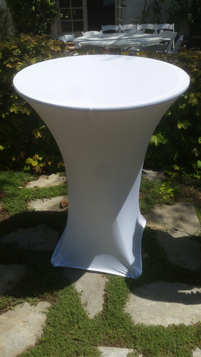 Round highboy cocktail tables with white tablecloths.